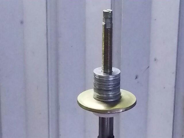Washers stacked on the upper mount to raise its position without adding spring preload