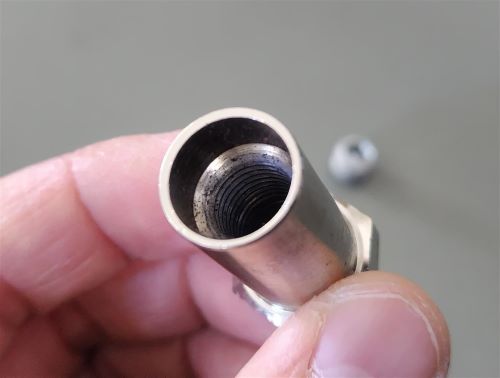 A cross-section of the sleeve nut showing the internal threading