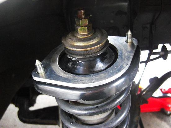 A spacer attached to the upper mount of a coilover